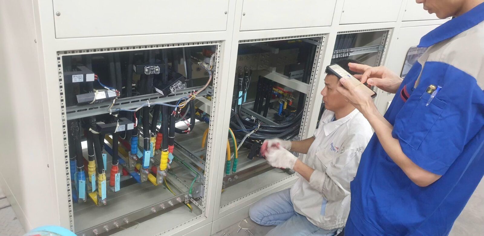 Kỹ thuật viên đấu nối biến dòng đo lường trong tủ điện, đầu cáp đánh nhãn theo pha